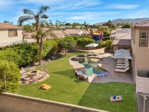 Aerial of the backyard with pool and fire pit at Coachella Sol Haus, a Indio, CA vacation rental