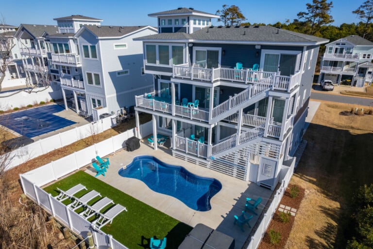Aerial of the house with pool and turf yard at Salt & Lighthouse, a Corolla, NC vacation rental