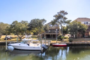 Boats docked on the canal behind the house at Pescadora, a Frisco, NC vacation rental