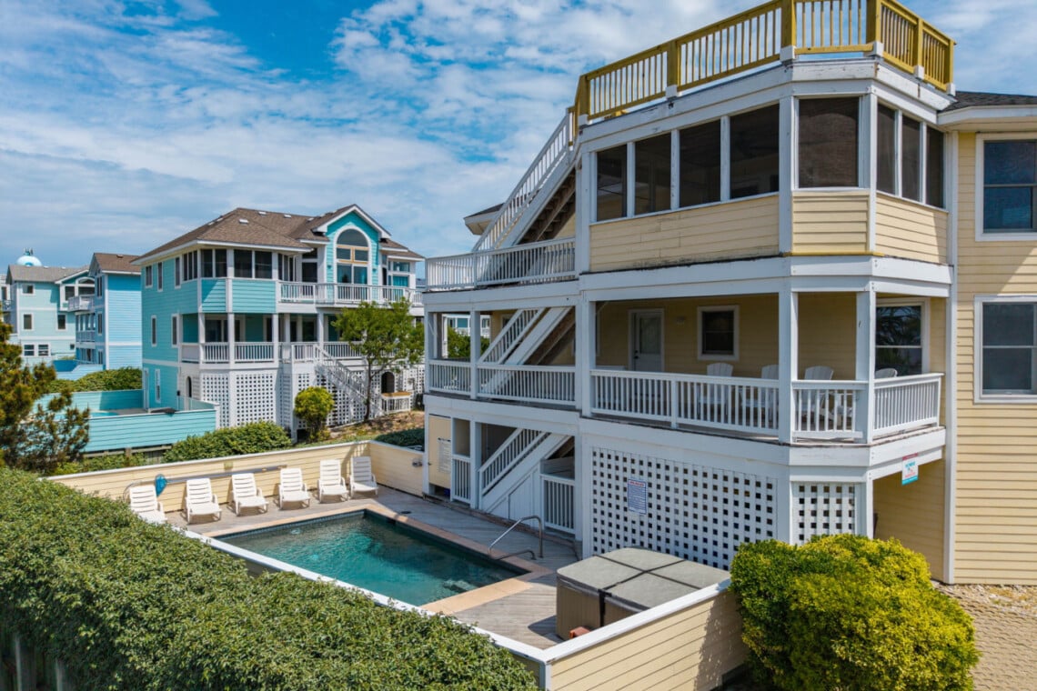 Exterior of the three-story beach house with porches at Heron Landing, a Corolla, NC vacation rental