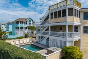 Exterior of the three-story beach house with porches at Heron Landing, a Corolla, NC vacation rental