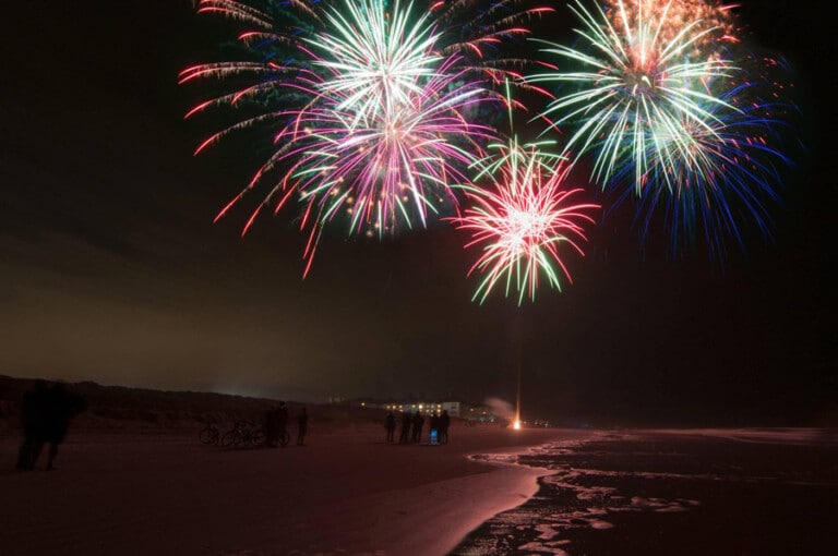Fireworks over the beach at night