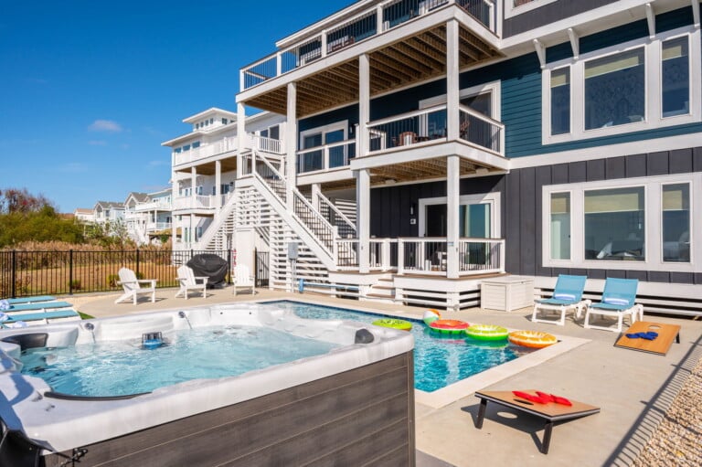 Rear exterior with pool and hot tub at Hygge on the Bay, a Corolla, NC vacation rental